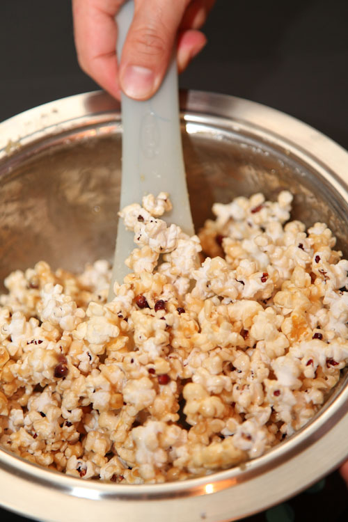 Toss the popcorn to coat it evenly with the caramel