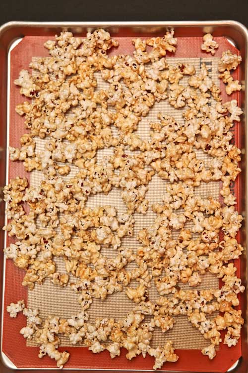 spread the popcorn evenly on the baking sheet in one layer