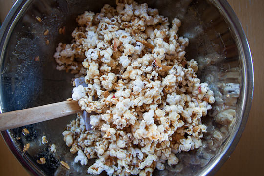 Stirring the caramel into the popcorn. Photo by Irvin Lin of Eat the Love. | www.eatthelove.com