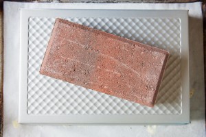 Place a 9 x 13 baking pan over the bialys and then a brick on top of the pan. Photo by Irvin Lin of Eat the Love.