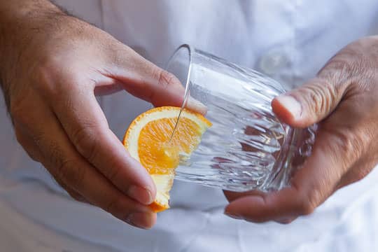 Rub the rim of the glass with an orange wedge. Photo by Irvin Lin of Eat the Love.