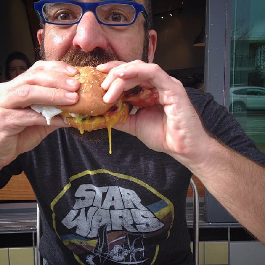 AJ eating a Super Duper burger. Photo by Irvin Lin of Eat the Love.