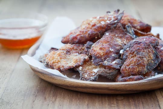 Fried Chicken Skins. Served with homemade smoked honey. Recipe and Photo by Irvin Lin of Eat the Love.