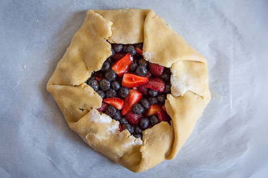 Pleat and fold the crust over the berry filling. Process photo by Irvin Lin of Eat the Love.