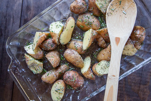 Toss the potatoes with the olive oil and herbs. Process photo by Irvin Lin of Eat the Love.