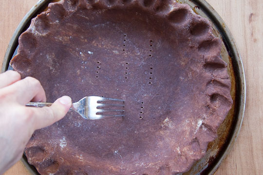 Prick the bottom of the crust with a fork. Process photo by Irvin Lin of Eat the Love.
