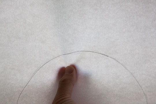 Fold the paper in half so the circle outline matches. Photo and tutorial by Irvin Lin of Eat the Love. 