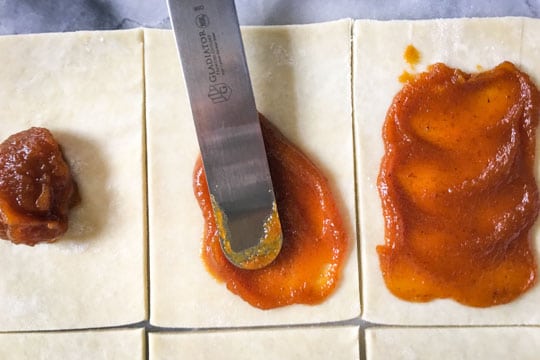 Place 1 tablespoon of pumpkin butter in the middle of each rectangle and spread it out.