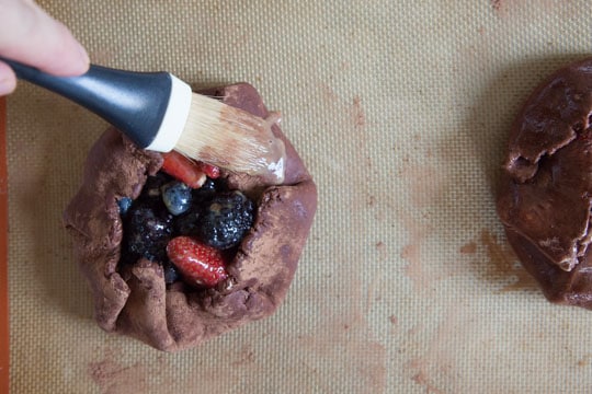 Brush the disk with the egg wash around the crust. 