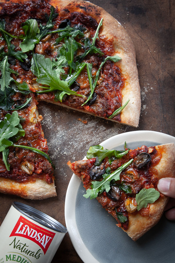 Double Olive Pizza with Sausage and Arugula. 