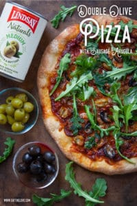 Double Olive Pizza with Sausage and Arugula.