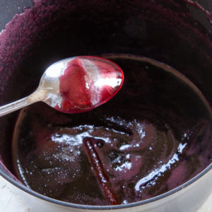 reduce the wine syrup until it is thick, coats the back of a spoon, and holds a line.