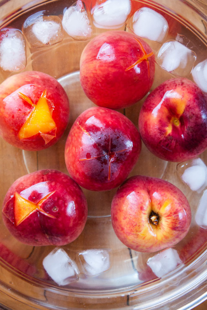 Dunk the peaches in ice cold water to shock them. Then peel!