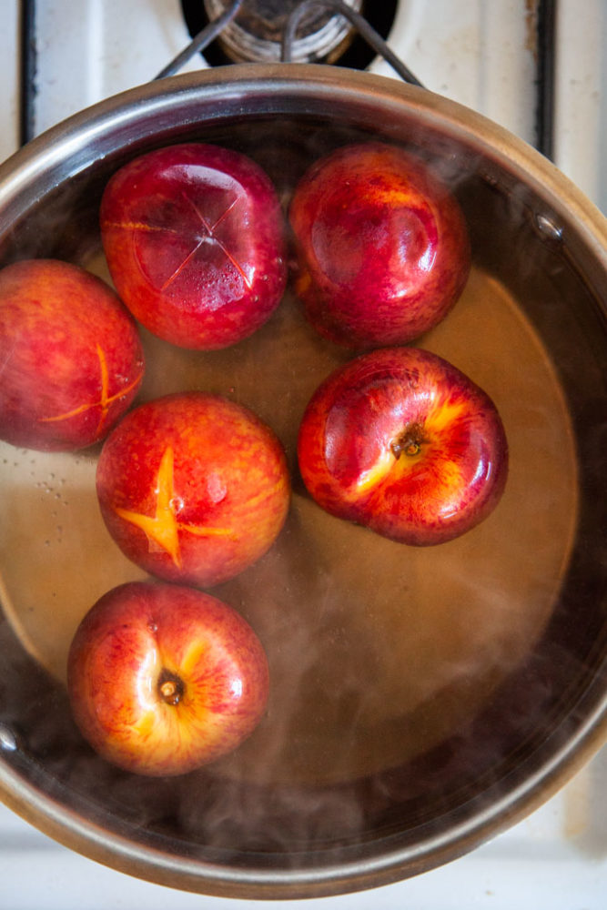 Quickly blanch the peaches in boiling water then peel!