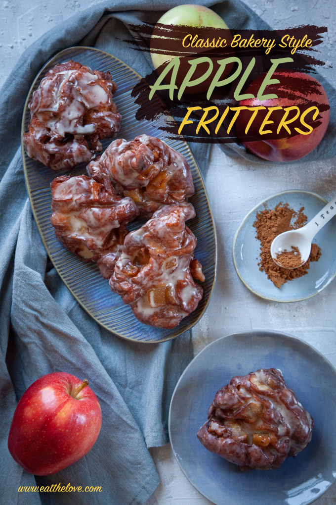 Homemade Apple Fritters on a plate, next to apples and a small dish with cinnamon.