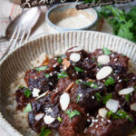 Moroccan lamb tagine with prunes in a ceramic bowl.