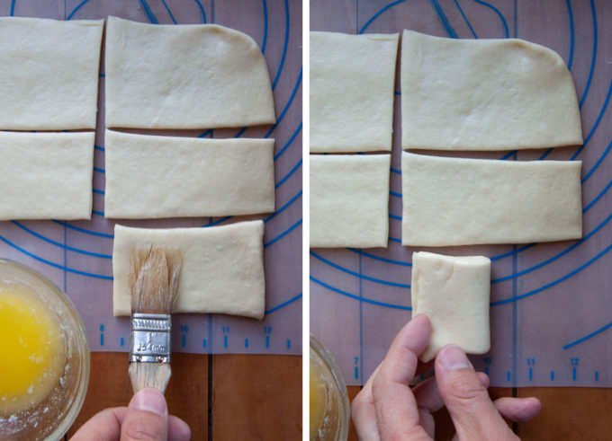 Brush half of one of the small rectangles with butter. Then fold it over.
