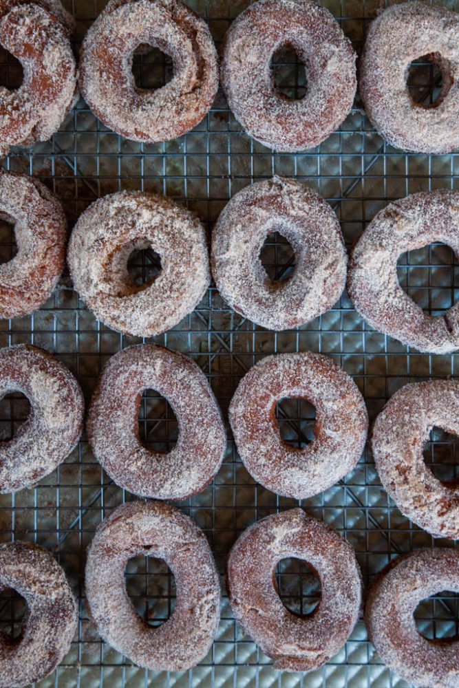 apple cider donuts on a wire rack.