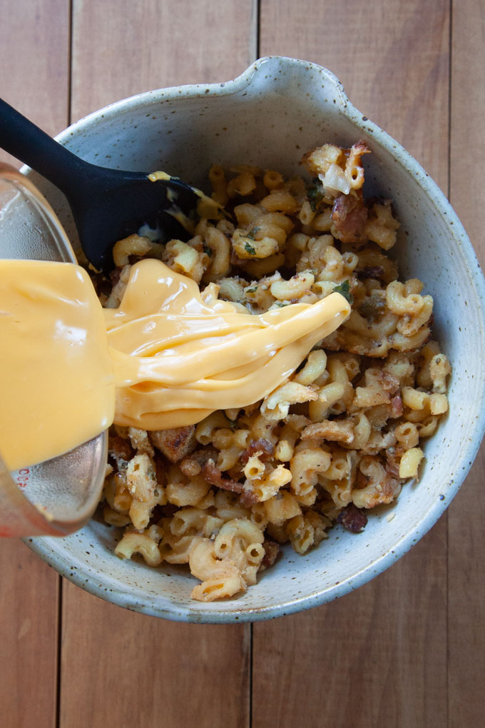Drizzling melted cheese over cold mac and cheese.