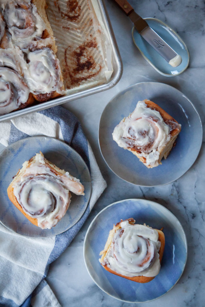 Eggnog cinnamon rolls on a small blue plates.