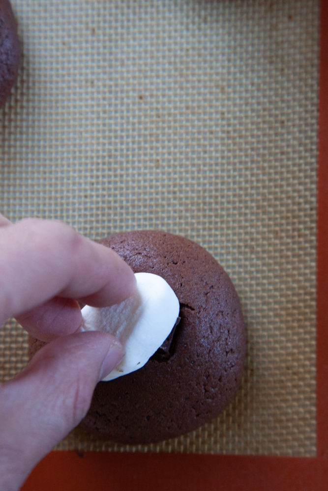 Placing marshmallow on the warm cookie.