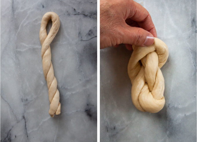 A hand forming the pretzel twist by pulling the dough into a knot.
