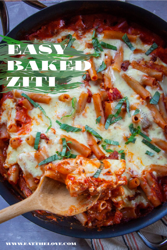 Easy baked ziti in a saute pan with a spoon scooping out some.