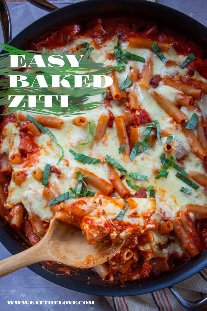 Easy baked ziti in a saute pan with a spoon scooping out some.