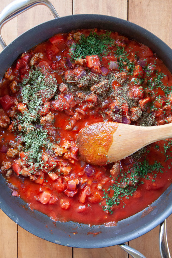 Dry fragrant Italian spices sprinkled over a tomato sauce.