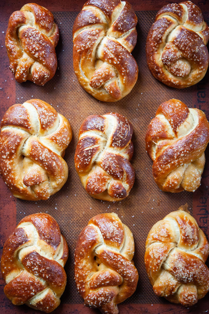 Soft beer pretzel twists on a baking pan.