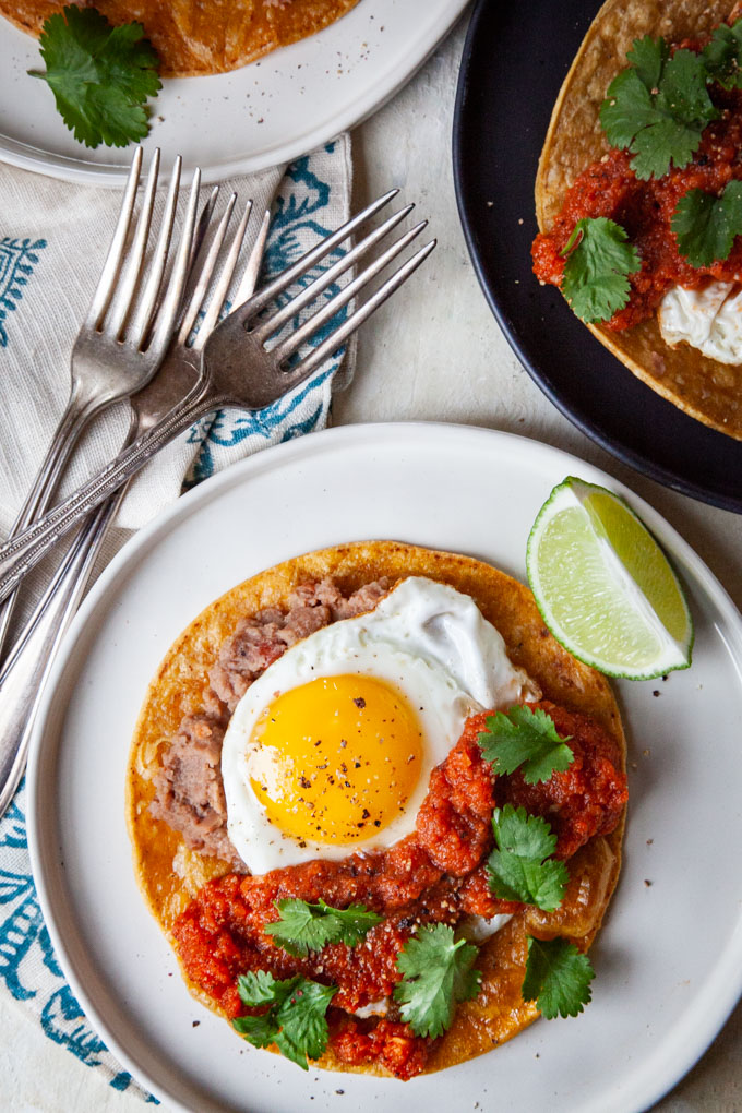 Huevos Rancheros (rancher egg tacos) on plates.