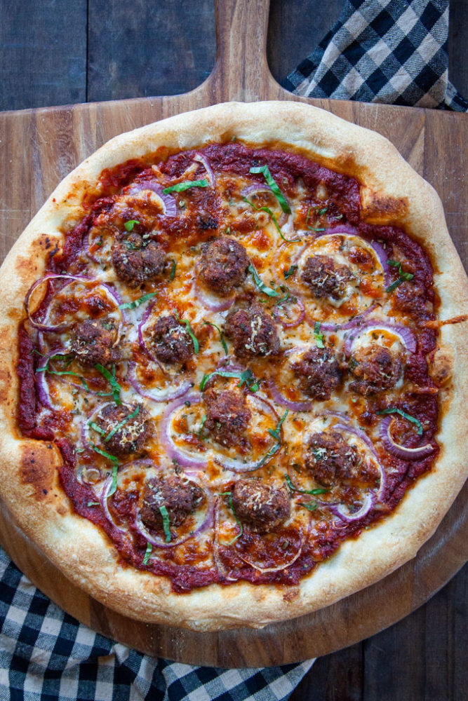 Meatball pizza on a pizza peel