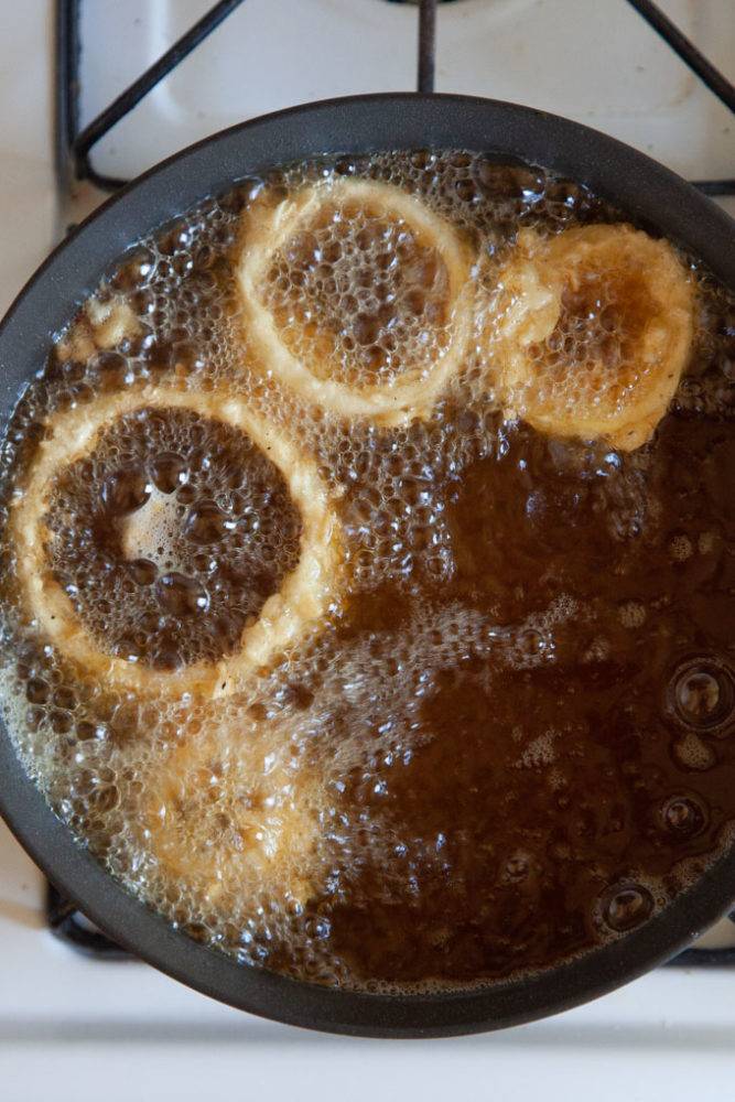 Frying onion rings in hot oil.