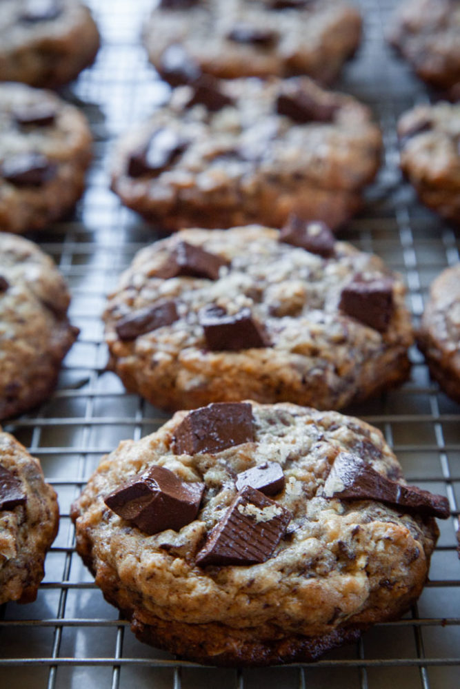 sourdough chocolate chip cookies cooling on a wire rack.