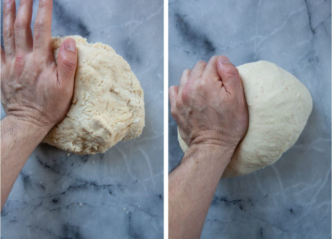 a hand kneading dough on a marble surface.