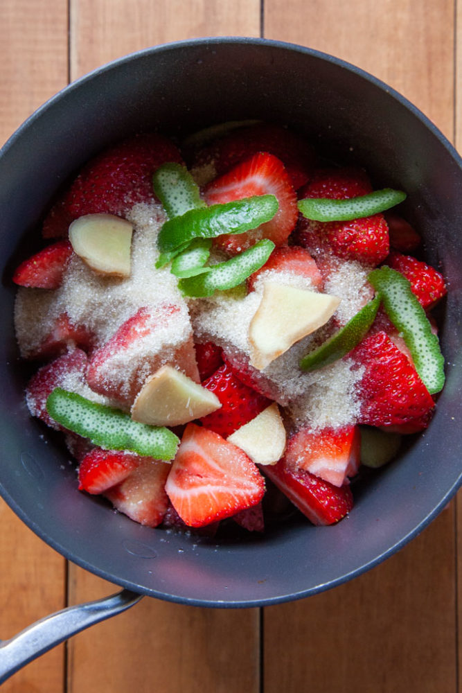 chopped strawberries, rhubarb, ginger and lime zest with sugar and water in a pot.