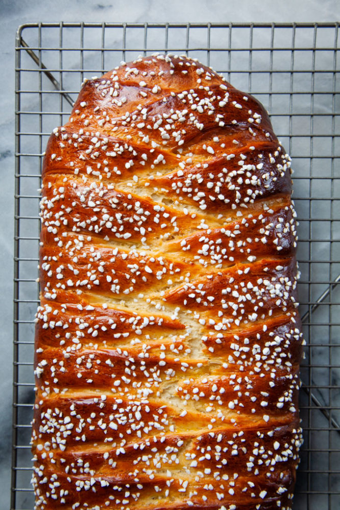 Braided apricot yeast bread on a wire cooling rack.