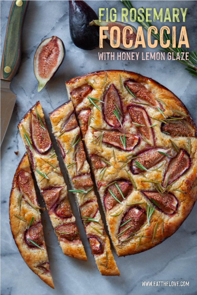 Fig rosemary focaccia cut up on a marble surface next to a cut fit and a knife.