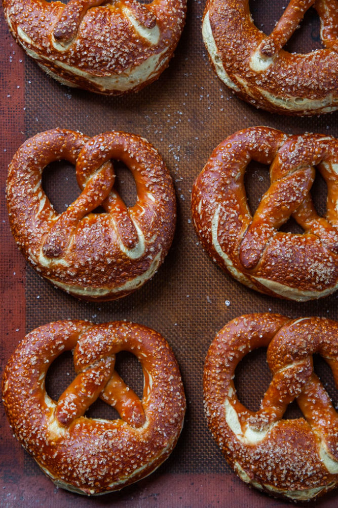 Bavarian Pretzels on a silicon baking mat lined baking sheet..