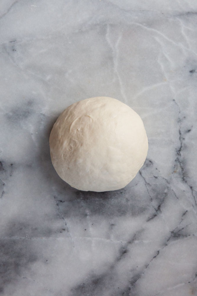Pizza Dough on a marble surface.
