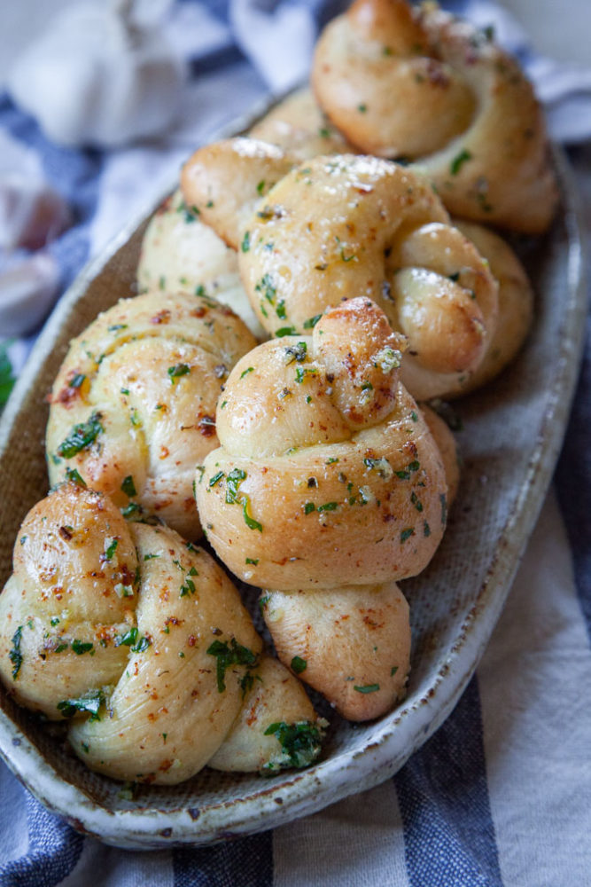 A pile of garlic knots on a plate.