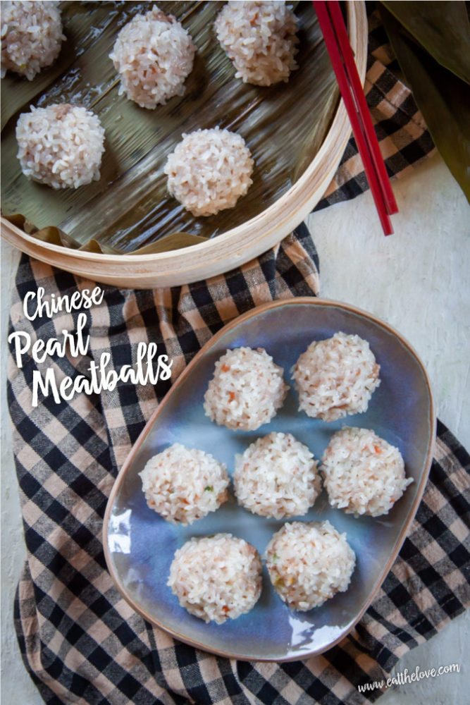 A blue plate of Chinese pearl meatballs on a checked cloth napkin with a bamboo steamer basket of more pearl meatballs in it.