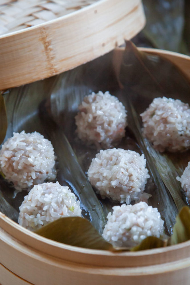 Chinese pearl meatballs in a bamboo steamer.