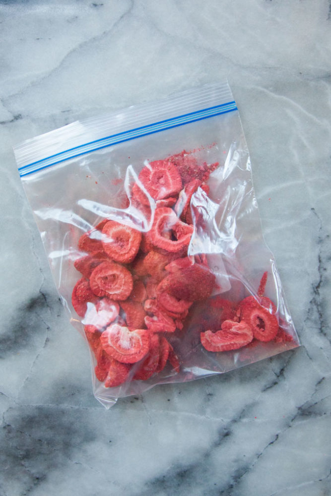 A Ziploc bag filled with freeze dried strawberries slices.