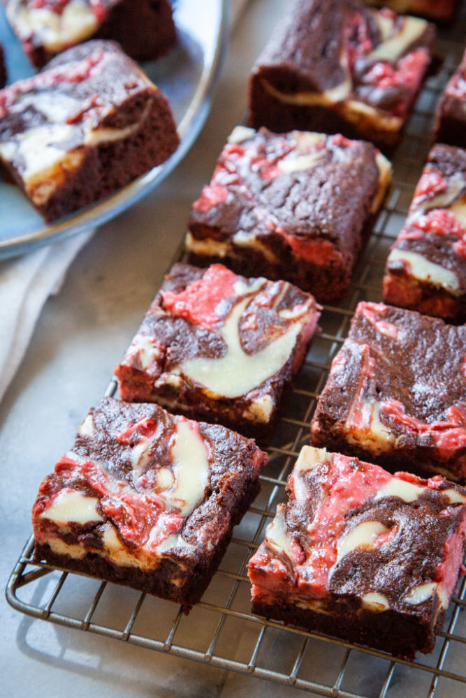 Neapolitan brownies sitting on a wire cooling rack.