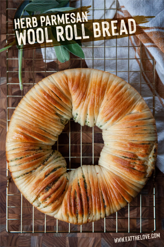 Herb wool roll bread on a wire cooling rack.