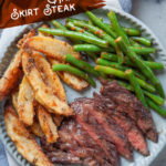 A plate with sangria marinated grilled skirt steak, potato wedges and green beans.