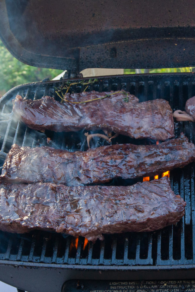 Sangria-inspired marinated skirt steak being grilled.