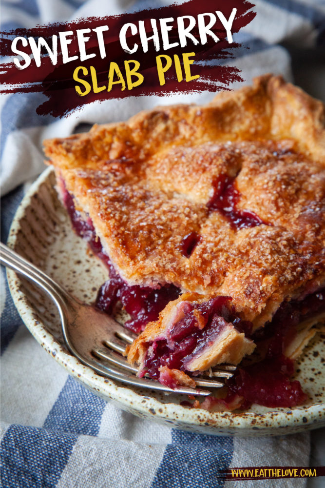 A slice of cherry slab pie on a plate with a fork that has taken a piece out of it.