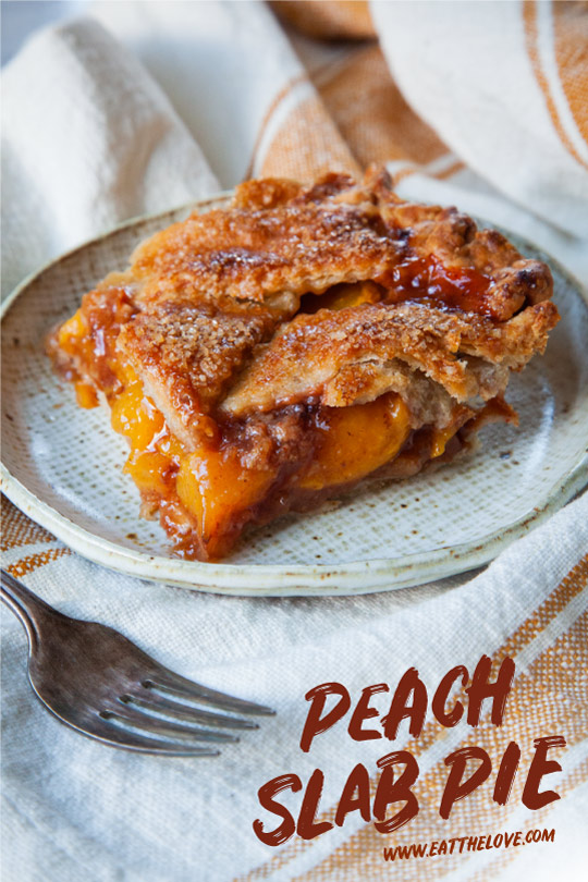 A piece of peach slab pie on a plate with a fork next to it.